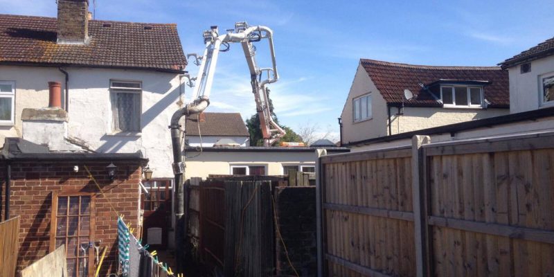 Easymix delivering concrete into a residential back garden